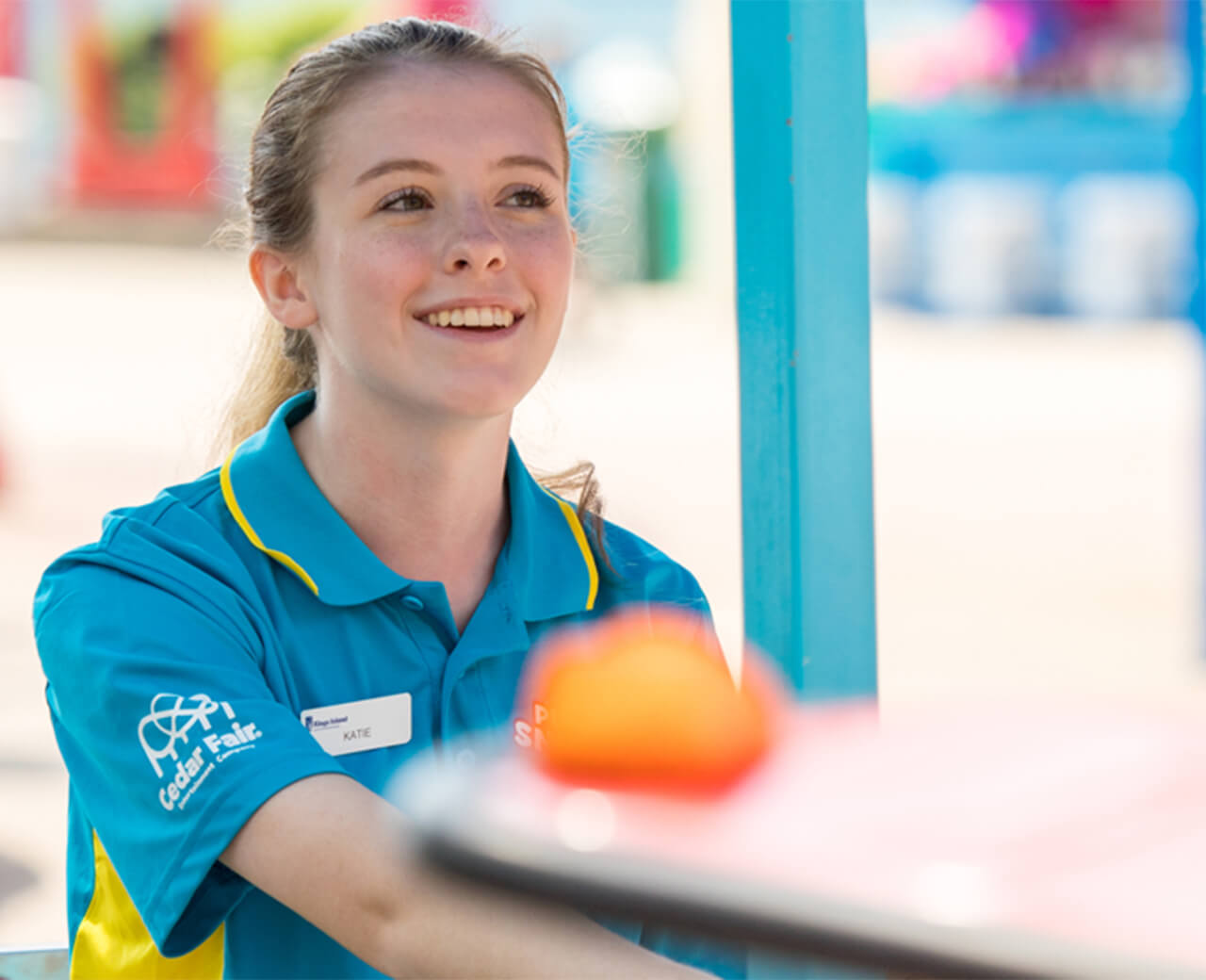 Cedar Fair employee smiling in their amusement park