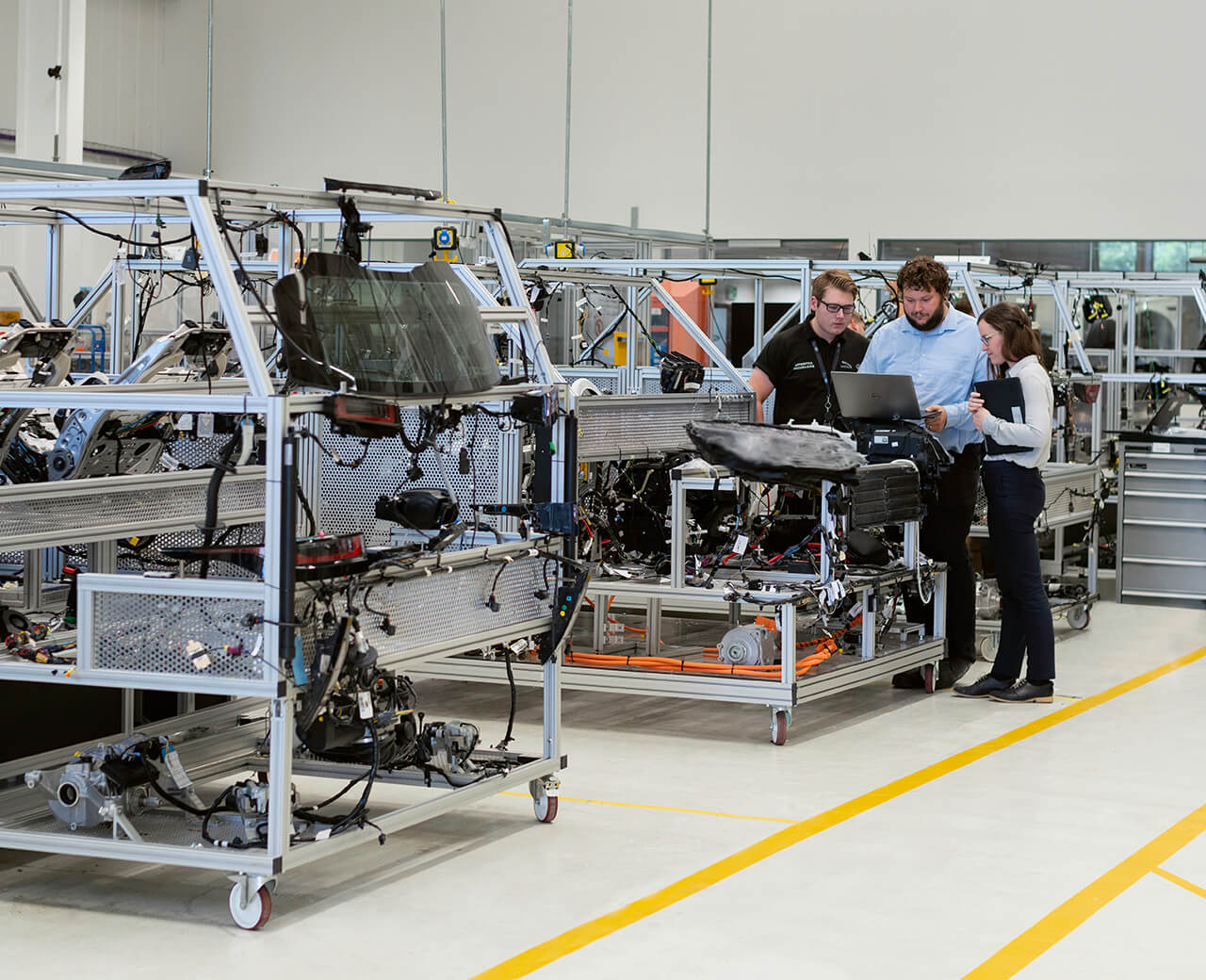 3 TT Electronics employees in a factory