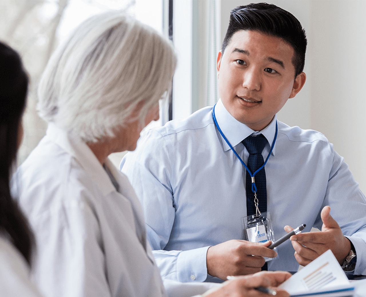 Infirmary Health employee consulting patient